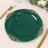 Green decorative plate with gold accents on a table setting.