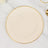 Elegant cream plate with scalloped edge and gold trim on a marble surface.