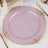 Pink decorative plate with gold ornate edges on a white tablecloth.
