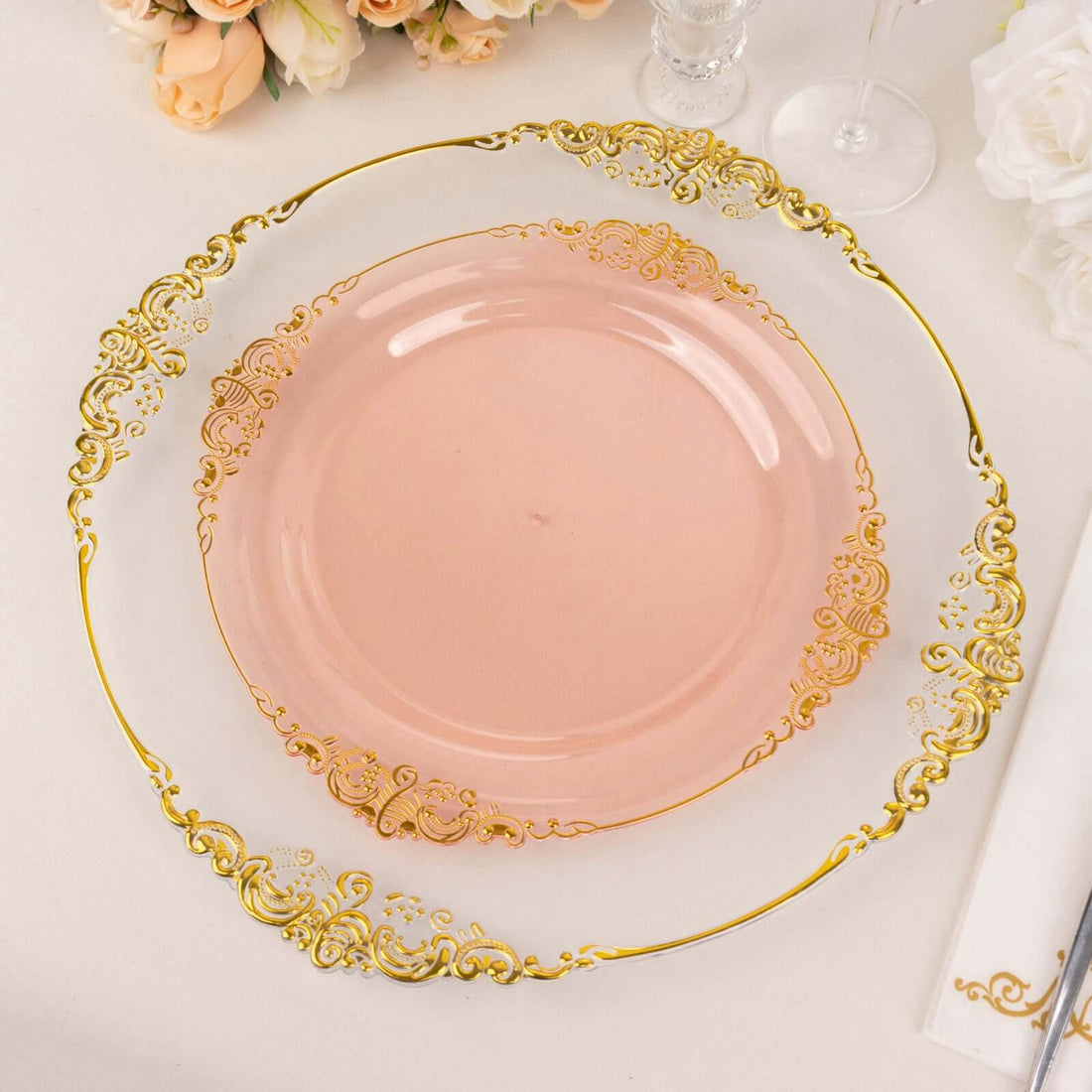 Elegant pink and gold decorative plate on a table setting.