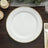 White dinner plate with gold bead trim on wooden table.