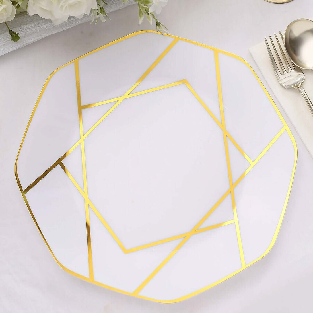Elegant octagonal plate with gold geometric design on a white background