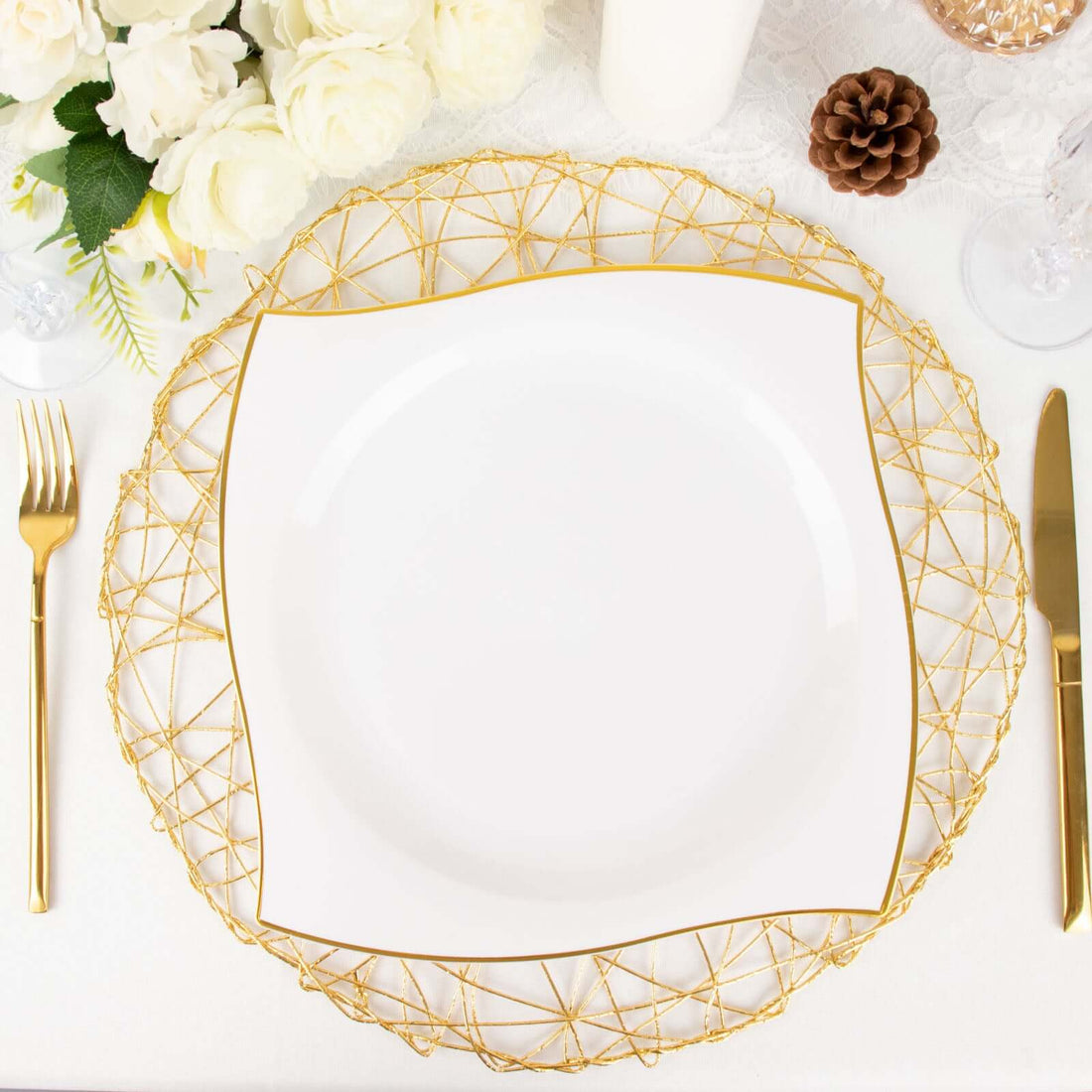 Elegant white plate with gold trim on a decorative gold charger.