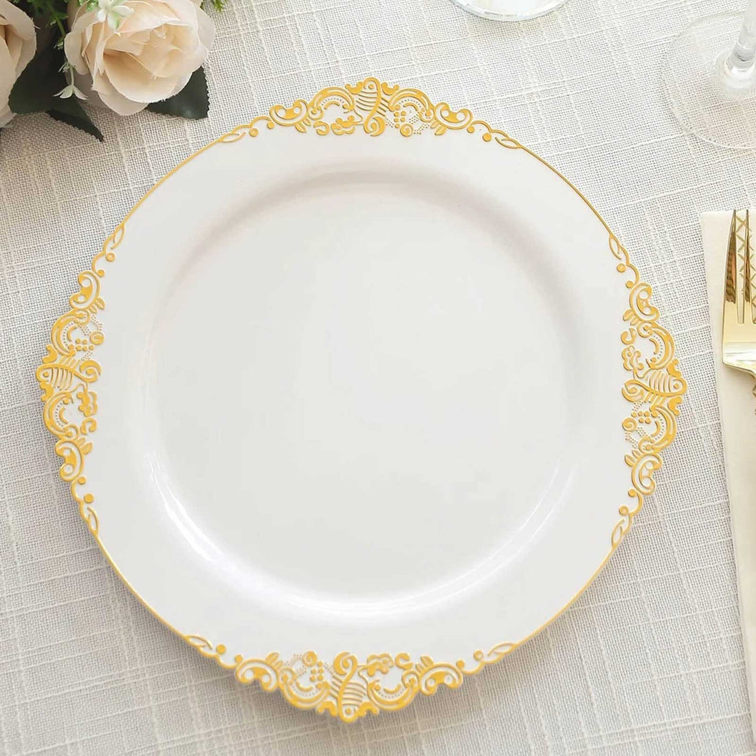 Elegant white dinner plate with gold ornate border design.