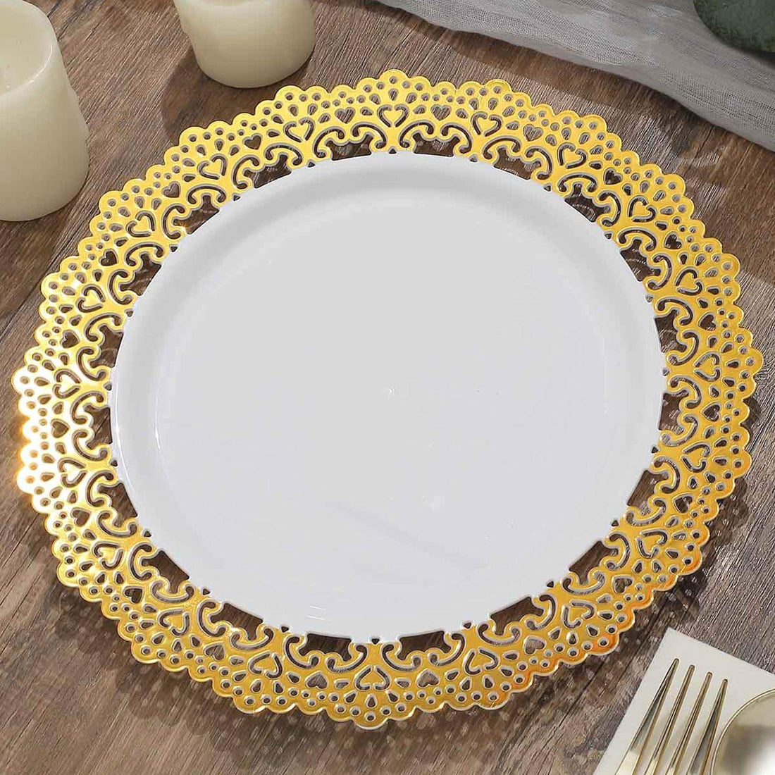 Elegant white plate with intricate gold lace design on a wooden table.