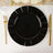 Black decorative plate with gold cutlery on a white table setting.