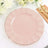 Pink scalloped plate with gold trim on a table setting.