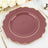 Elegant scalloped burgundy plate with gold trim on a table setting.