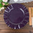 Purple decorative plate on a wooden table with floral accents.