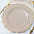 Elegant scalloped dinner plate in soft beige with gold trim.
