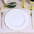 Elegant white scalloped plate with gold trim, styled with golden utensils and decor.