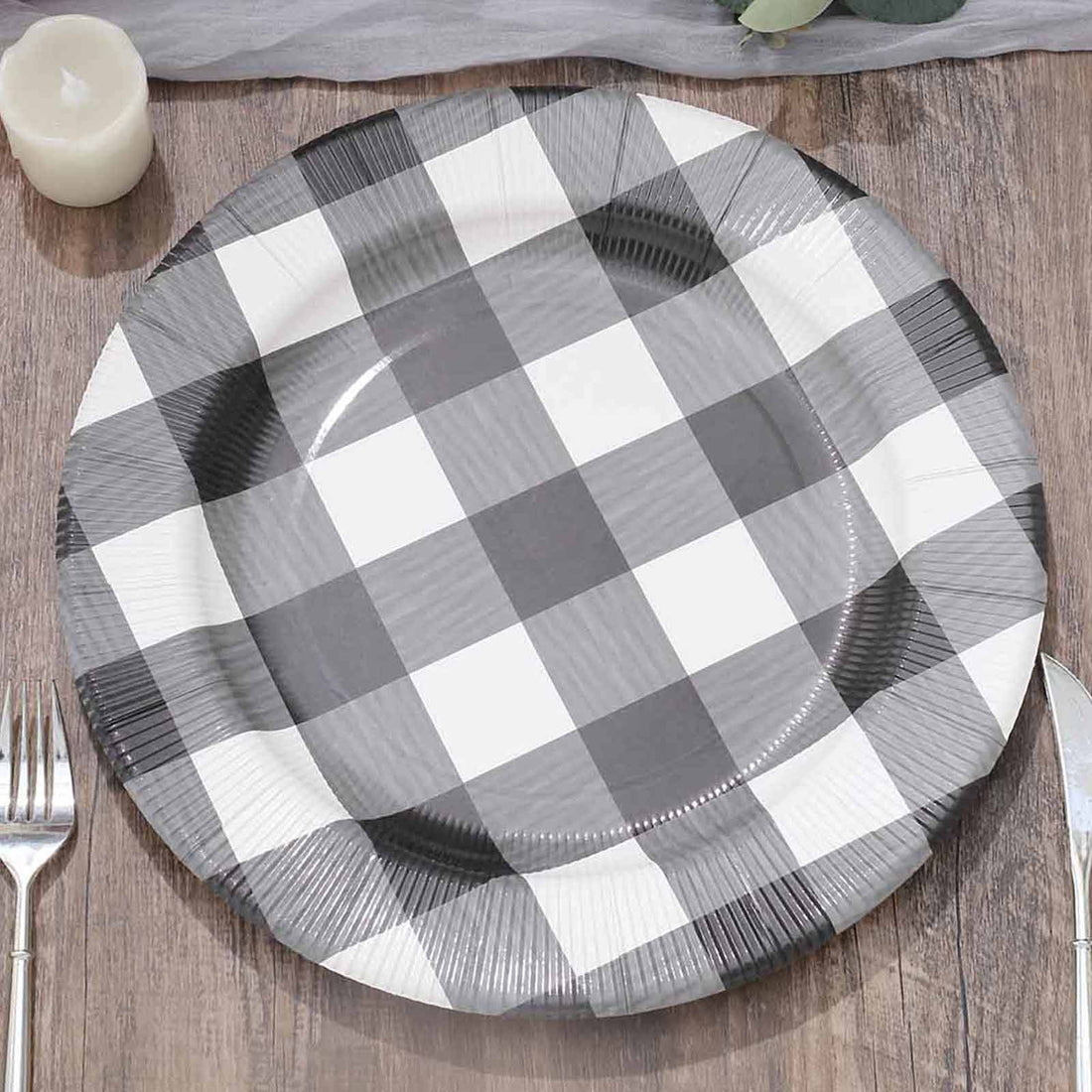 Black and white checkered paper plate on wooden table.