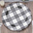 Black and white checkered paper plate on wooden table.