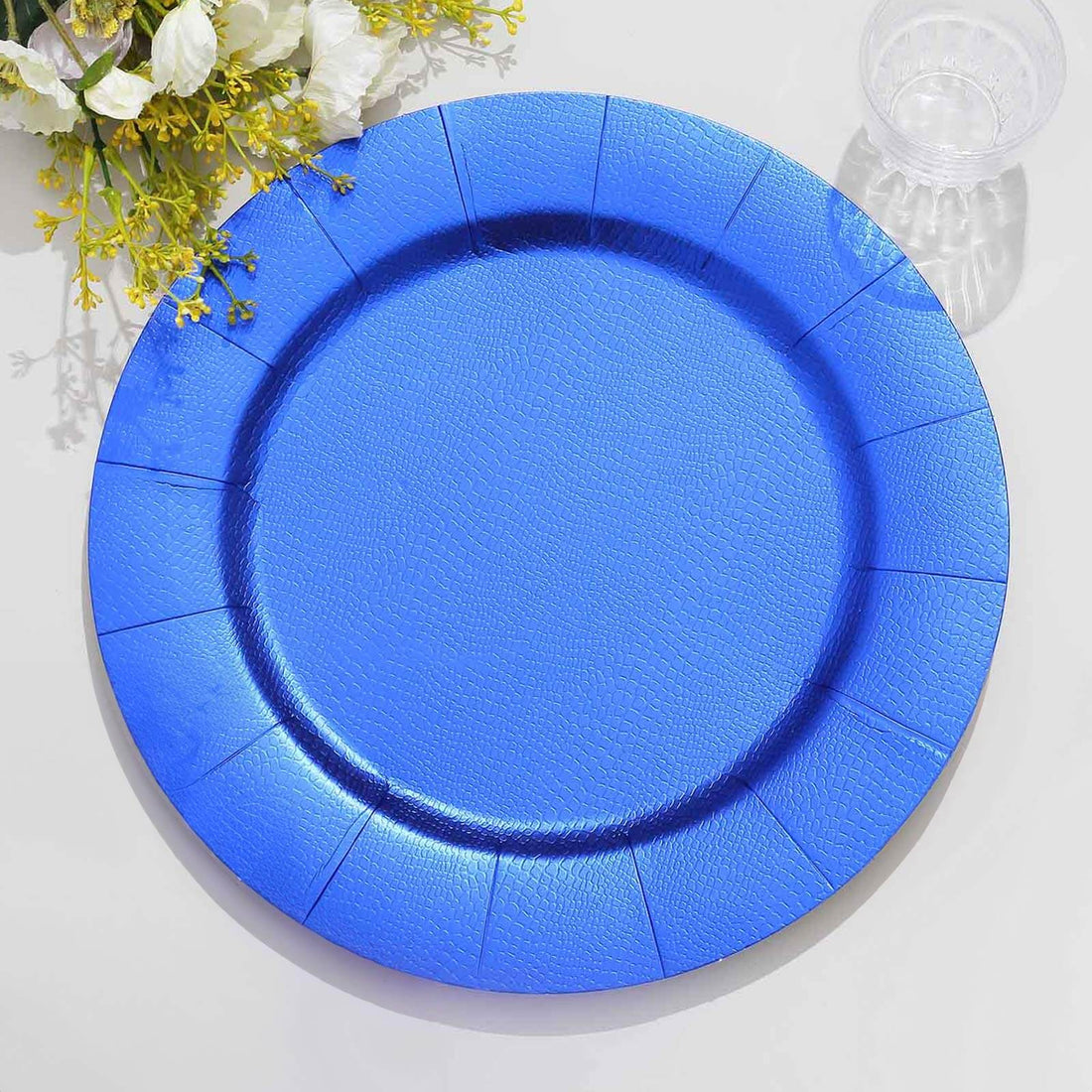 Blue disposable plate on a plain background.