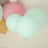 Colorful balloons in pastel shades floating against a light backdrop.