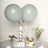 Gray balloons with a cake and flowers on a table setting.