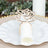 Rose-shaped napkin holder on an elegant plate setting.