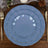 Elegant blue dinner plates set with gold trim on a wooden table.