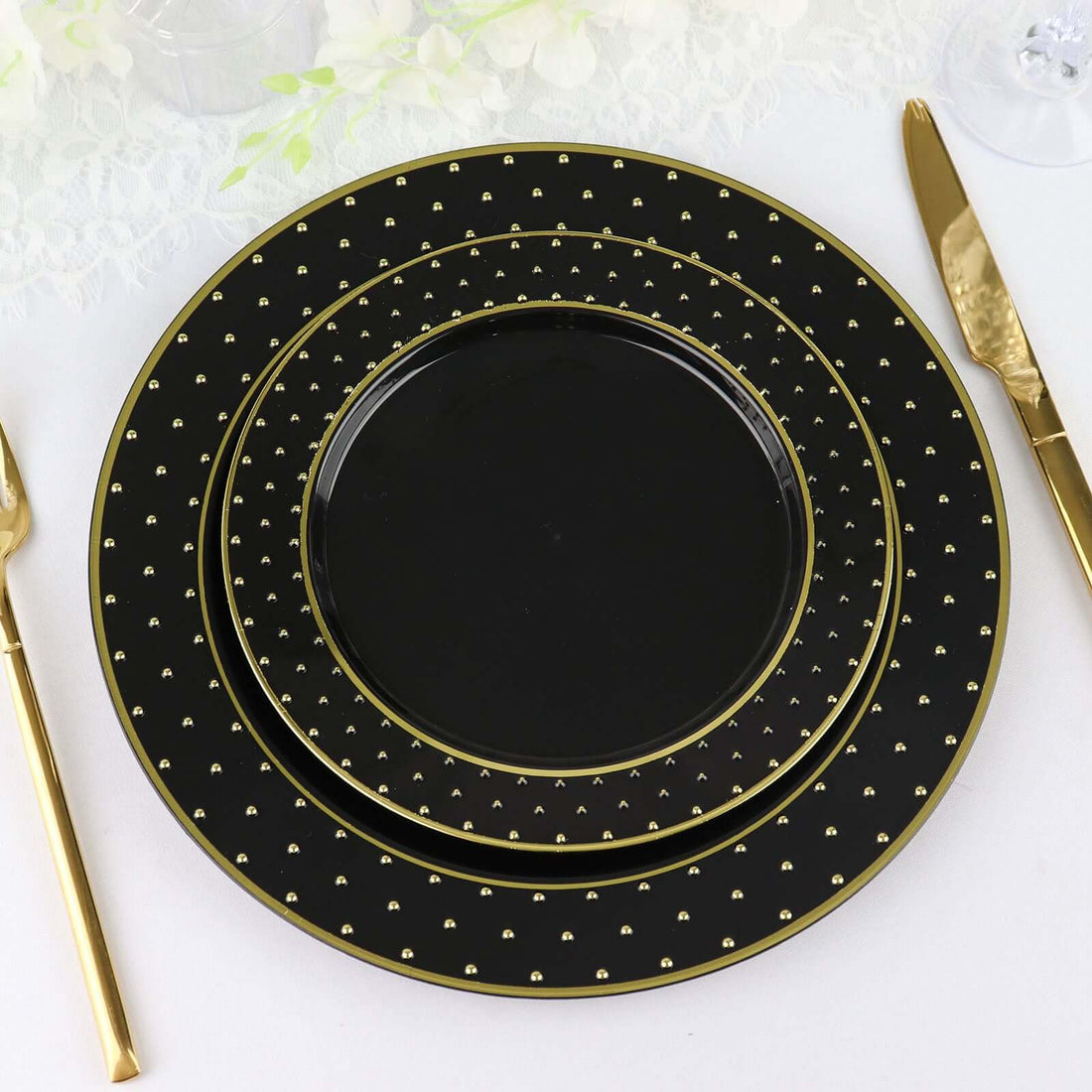 Elegant black plates with gold accents on a white background