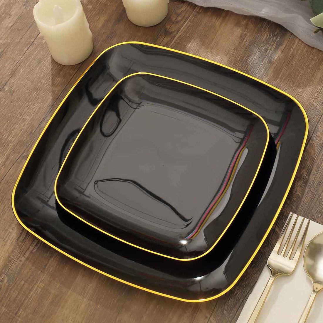 Black square plates with yellow trim on a rustic wooden table.