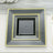 Black square plates with gold trim in three stacked sizes.