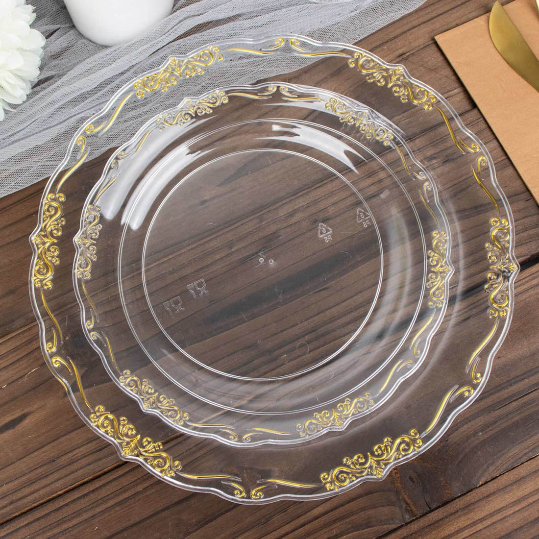 Clear decorative plate with gold accents on a wooden surface.