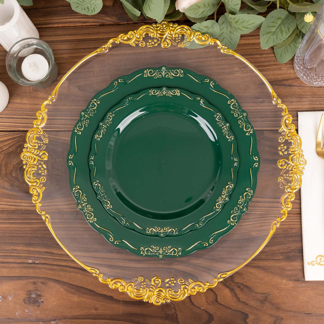 Elegant green and gold decorative plates stacked on a wooden table.