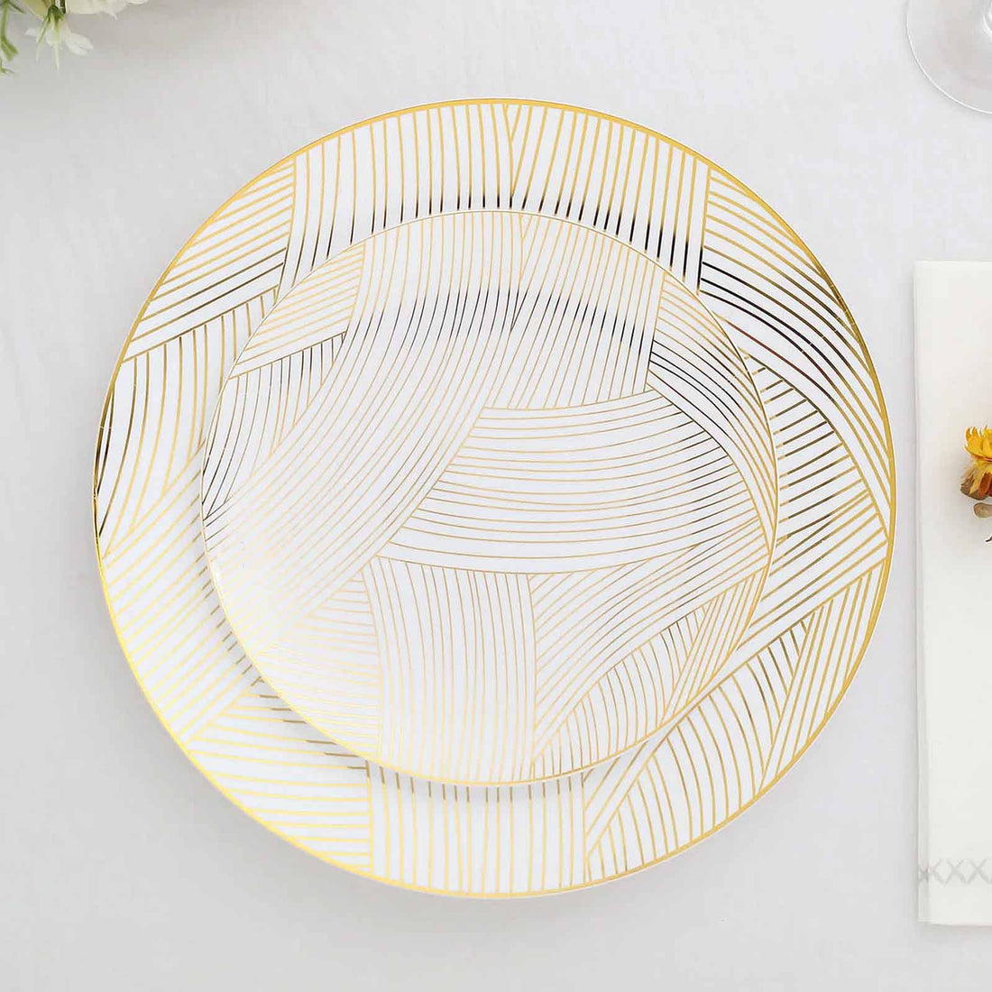 Elegant gold-accented decorative plate with a unique line pattern.
