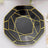 Black octagonal plate with gold geometric design