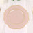 Pink scalloped plate with gold trim on a table setting.