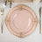 Elegant pink plate with gold embellishments, styled with silver cutlery.