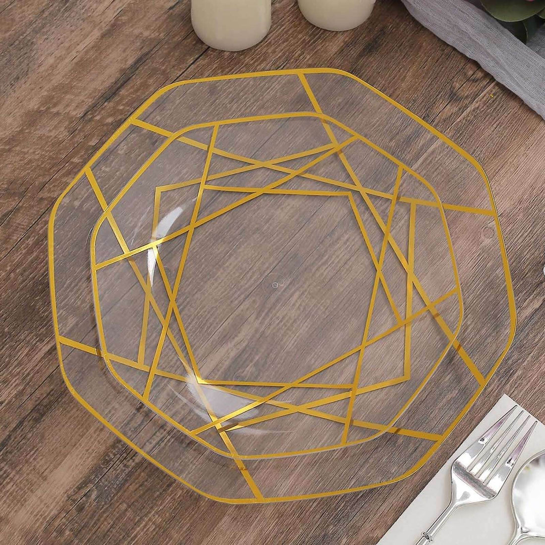 Clear octagonal plate with gold geometric design on a wooden table.