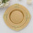 Gold decorative plates stacked elegantly on a white tablecloth.