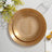 Elegant gold rimmed plates stacked on a table with floral accents.