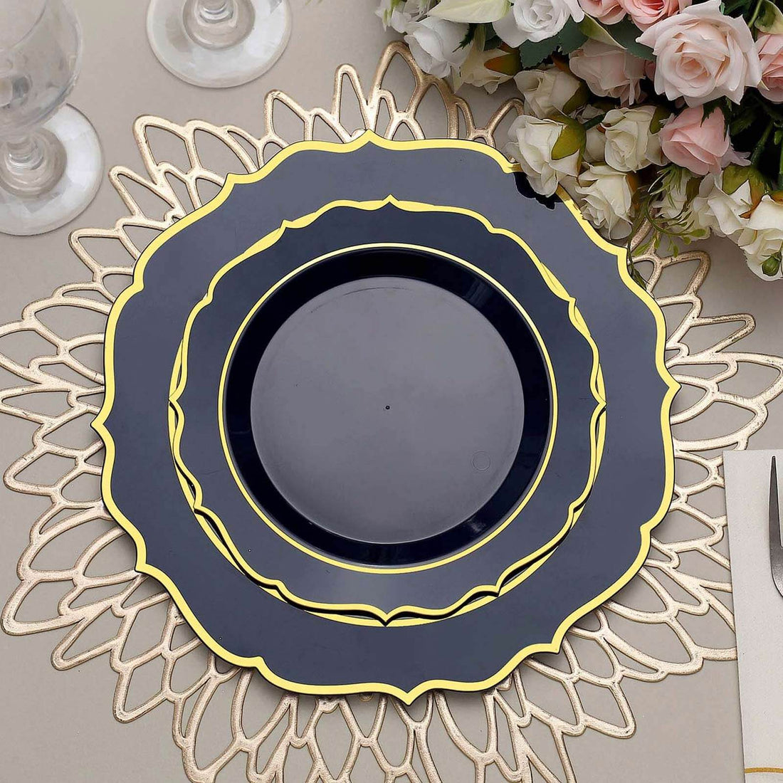 Elegant black and gold decorative dinner plate on a table setting.