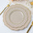 Elegant scalloped plates with gold trim on a dining table setting.