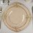 Elegant gold-trimmed dinner plate set on a textured tablecloth.