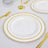 Elegant white plate with gold trim on a table setting.