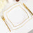 Elegant white plates with gold trim on a dining table setting.