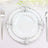Elegant white dinner plate with ornate silver rim design.