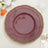 Burgundy scalloped dinner plate with gold trim on table setting