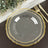 Elegant clear plate with gold trim on a dark wooden table setting.