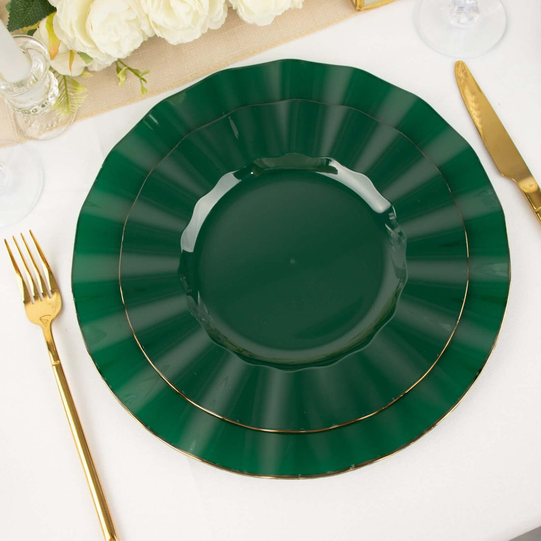Green decorative plates with gold rims arranged on a dining table.