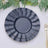 Navy blue decorative plate set on a table with greenery