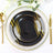 Elegant black plates with gold accents on a decorative table setting.