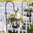 Decorative lantern with flowers on a stand for outdoor wedding decor.