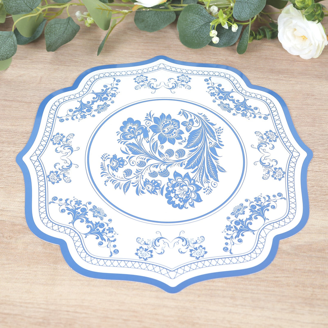 Blue floral decorative plate on a wooden surface.
