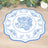 Blue floral decorative plate on a wooden surface.