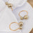 Gold pearl napkin rings on a white table setting.