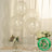 Biodegradable clear balloons with eco-friendly label on a table setting.